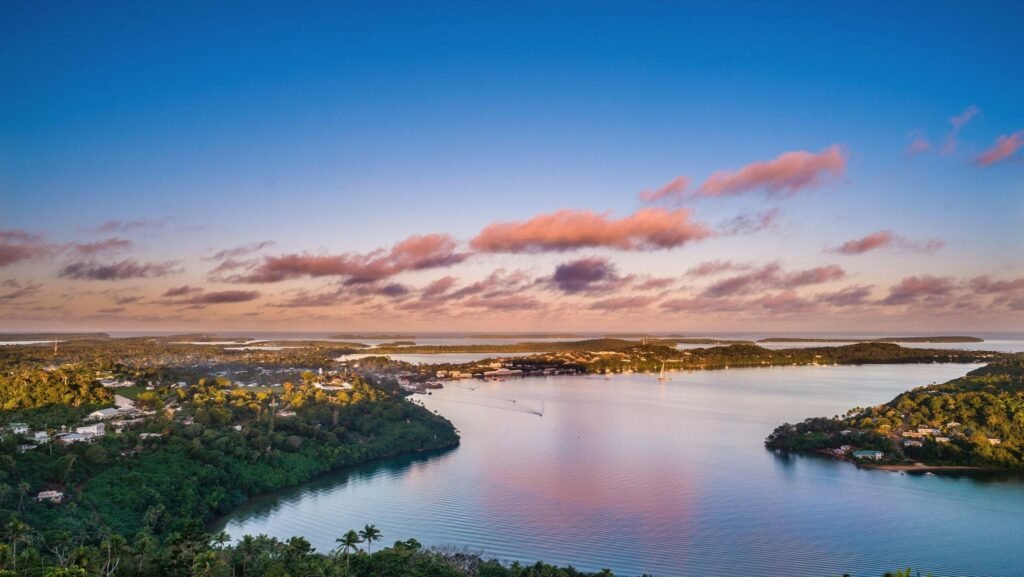 Island full of trees and houses surrounded by the ocean