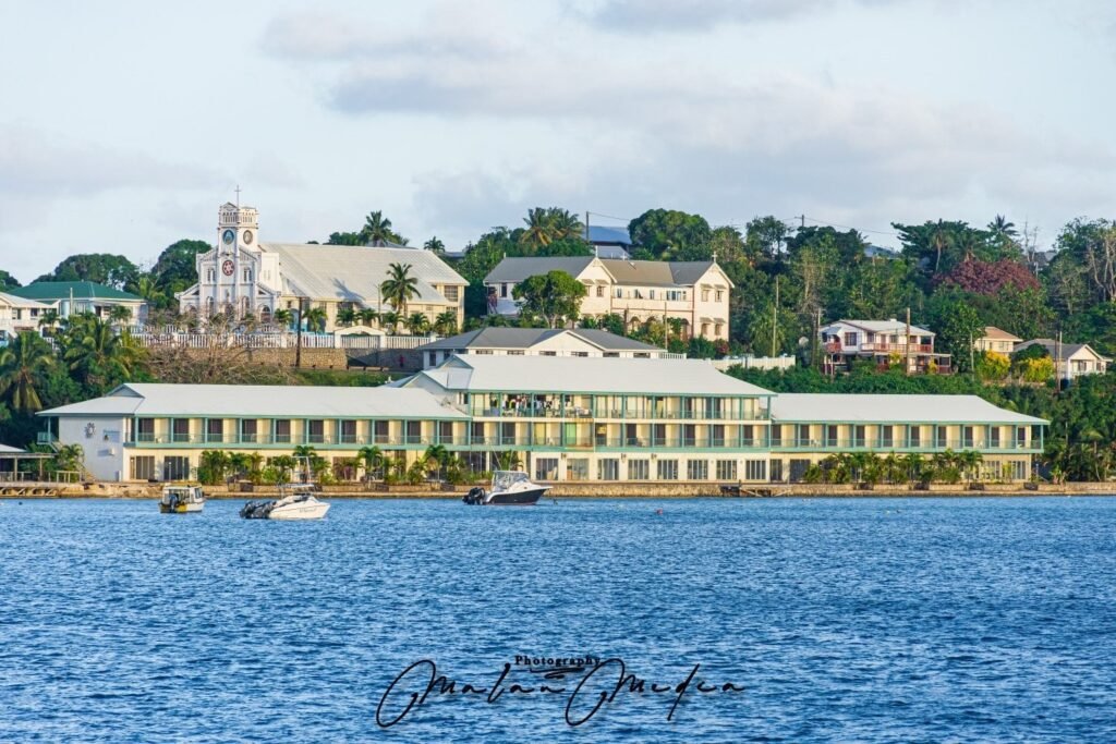 Buildings on an island overlooking the ocean with boats