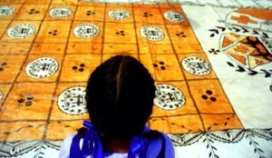 Girl standing infront of Tongan Ngatu 